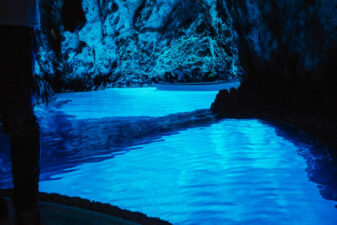 People visiting spectacular blue cave in boat, Modra Spilja, Bisevo, Croatia